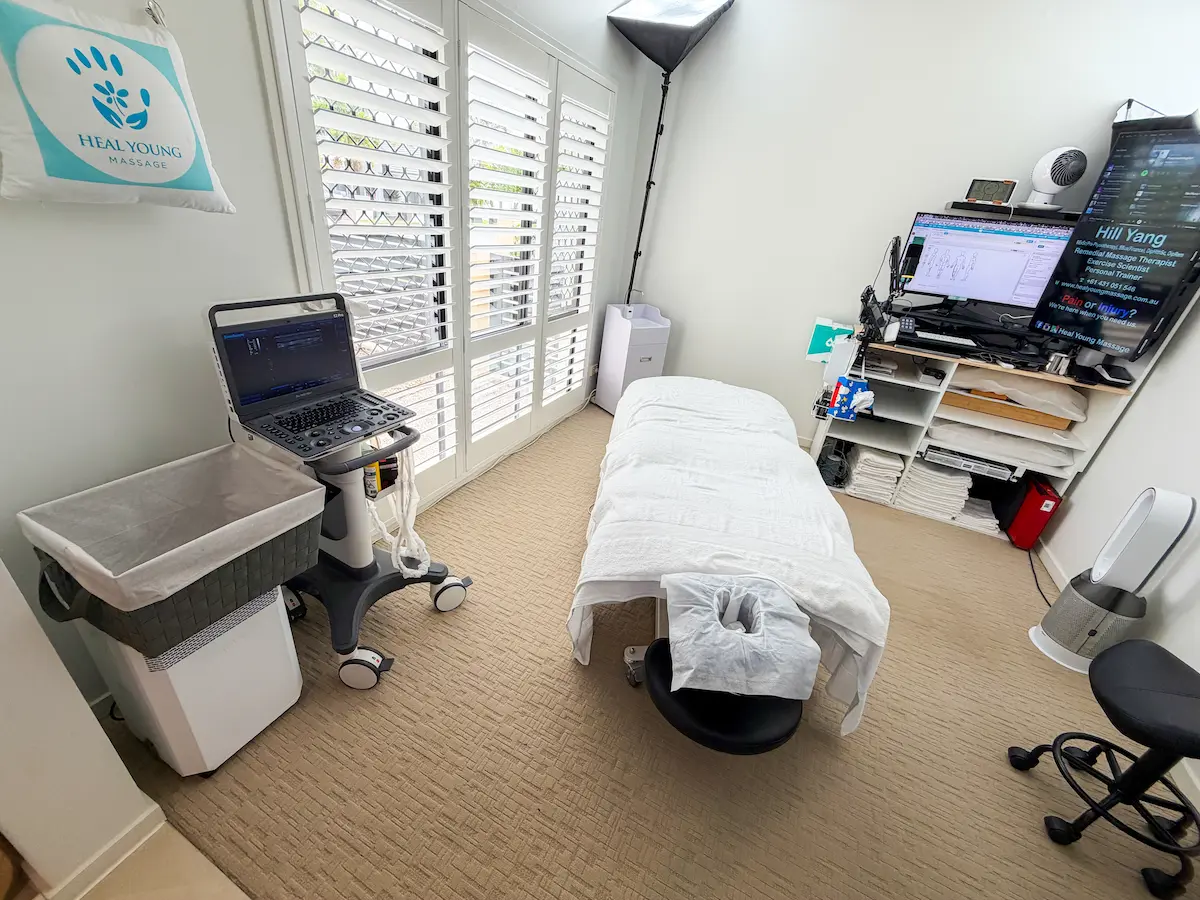 Inside the Heal Young Massage clinic treatment room at Varsity Lakes, Gold Coast — private, clinical setup with assessment and treatment equipment