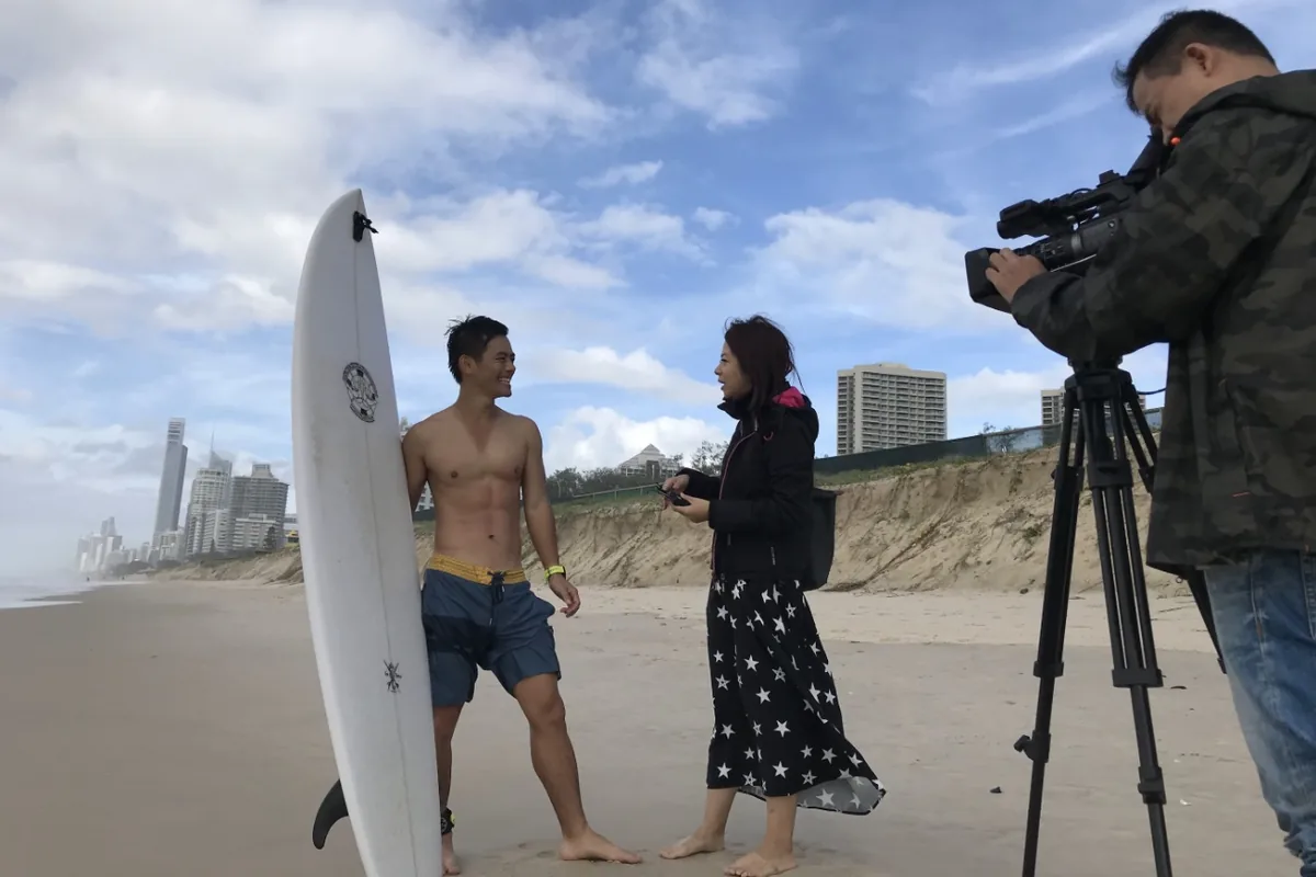 Hill Yang being interviewed by SET TV on the beach at Surfers Paradise, Gold Coast, 2019